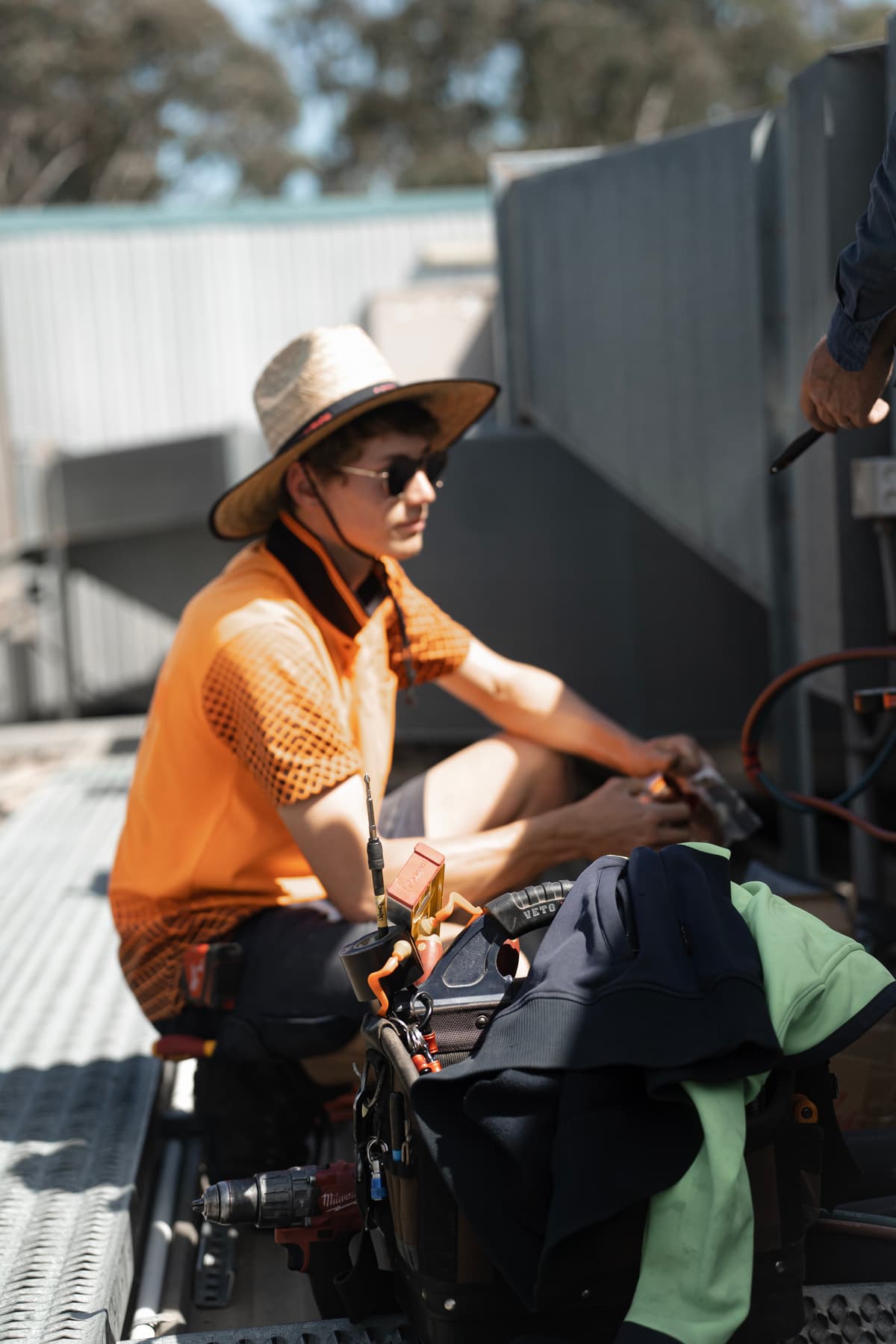 Professional air conditioning maintenance on rooftop platform