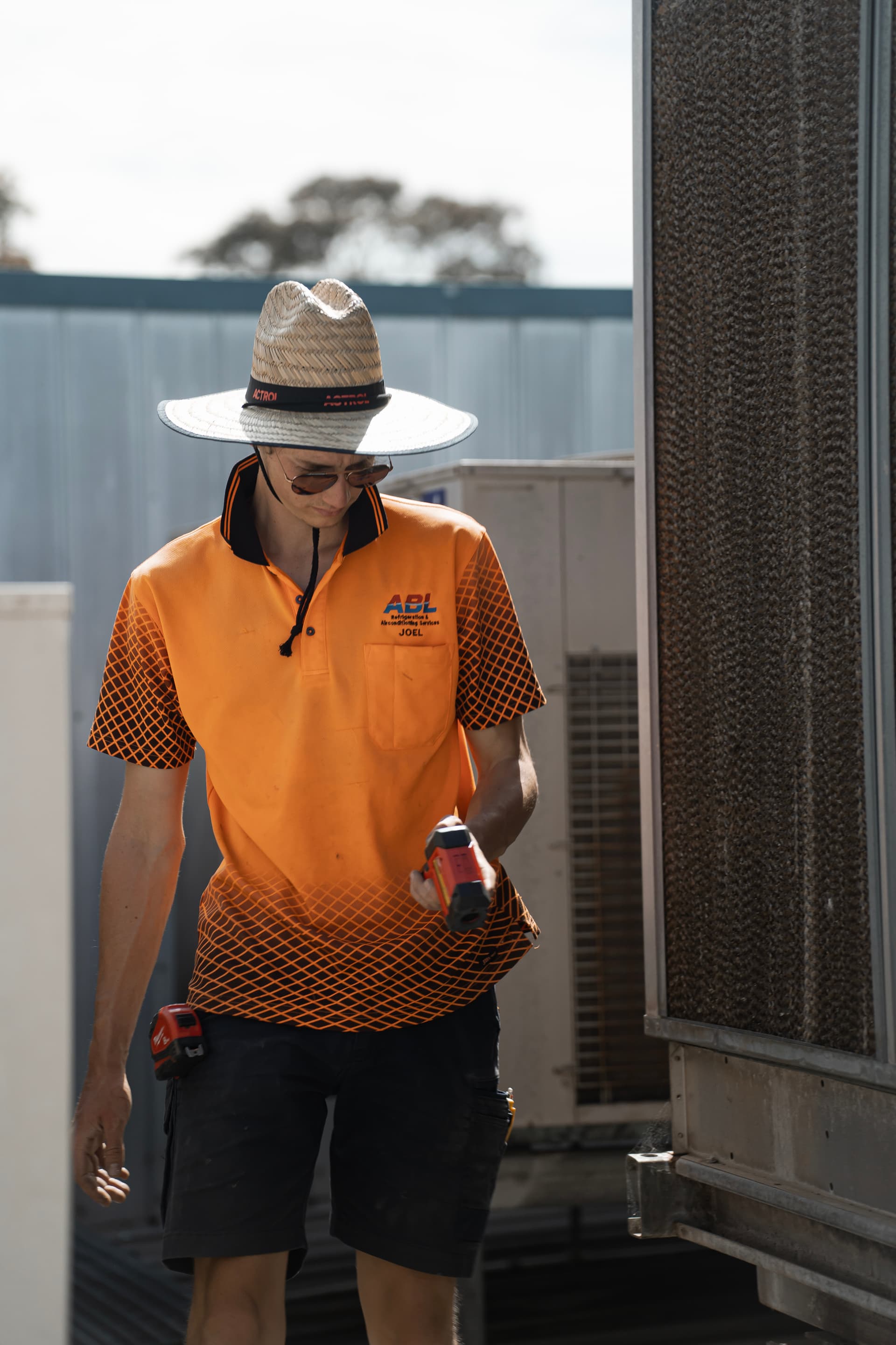 ABL technician Joel performing rooftop air conditioning maintenance